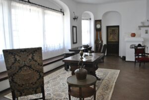 Elegant vintage living room featuring classic wooden furniture and a grandfather clock.